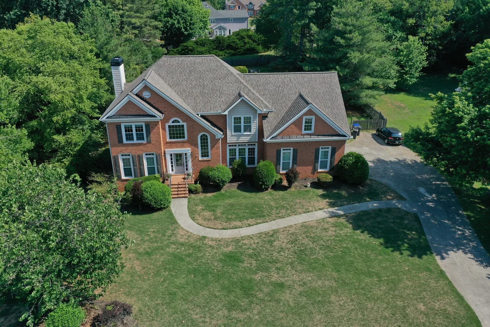 Before and after aerial of a residential roof replaced by Platinum Roofing